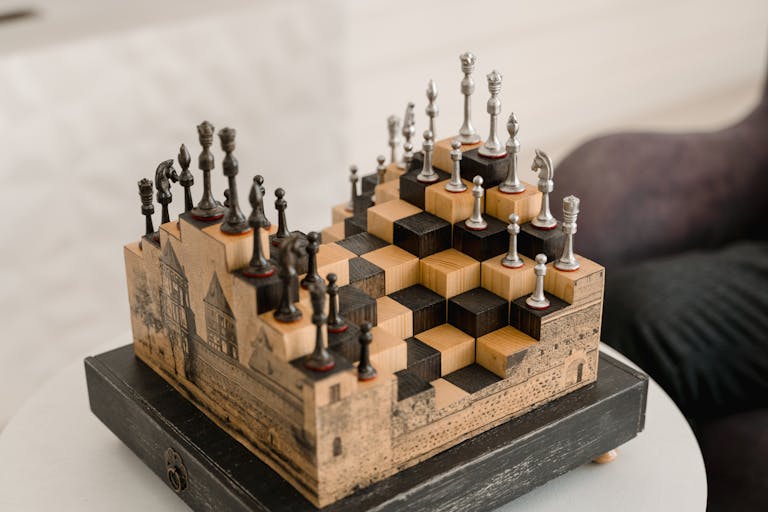 Artistic chess set with 3D pieces on an intricate wooden board indoors.